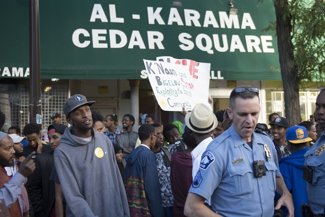 Protesters gather near the stage where K'naan performed on Saturday, Sept. 10, 2016 in the Cedar- Riverside neighborhood. K'naan was escorted away by security after protesters disrupted his performance. At at least 3 attendees were detained. Photo by: Easton Green