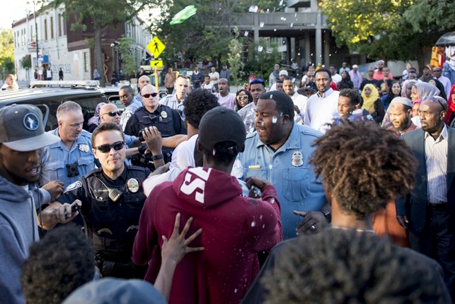 Officers prepare to spray the crowd when individuals started throwing plastic bottles and liquid at officers on Saturday, Sept. 10, 2016 in the Cedar-Riverside neighborhood. Photo by: Easton Green