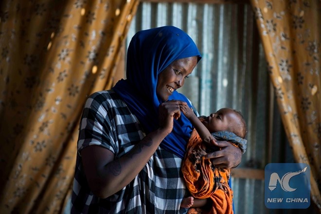 Fatuma and baby Seynab. Originally from Mogadishu, Fatuma has been living as a displaced person for the past 10 years. At 25, she already been through the ordeal of a divorce, death of a husband and two children. She lost her job of disposing garbage recently when the business was taken over by a private company. (UNICEF Somalia/Sebastian Rich)