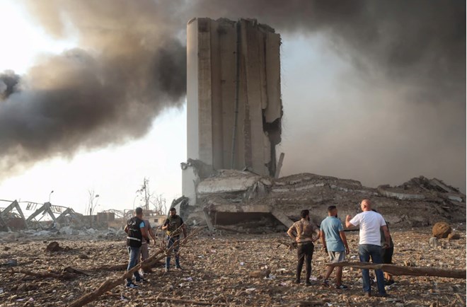 People gather by damaged buildings after a pair of explosions in Beirut on Aug. 4, 2020. (Hasan Shaaban/Bloomberg News)