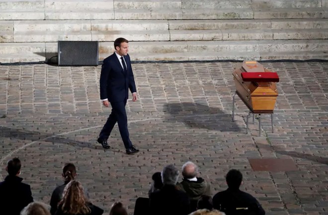 French President Emmanuel Macron walks past the coffin of slain teacher Samuel Paty during a memorial service Wednesday. (Francois Mori/Reuters)