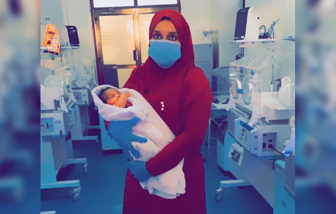 Zahra taking care of a newborn at the hospital
