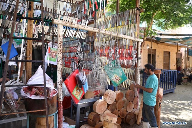 A vendor displays knives for sale before the upcoming Eid al-Adha at a market in Cairo, Egypt, on July 19, 2021. (Xinhua/Ahmed Gomaa)