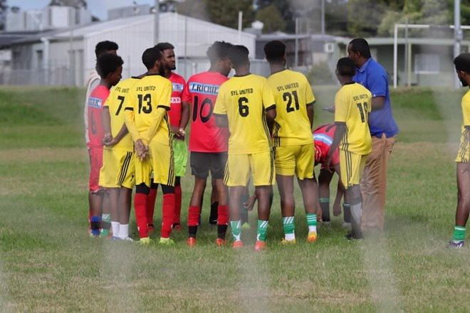 Ramadan Cup grand final contenders Future Stars United getting instructions from their coach. (ABC News: Lucas Hill)