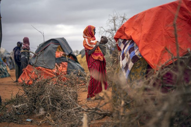 A Somali woman breastfeeds her child at a camp for displaced people on the outskirts of Dollow, Somalia on Tuesday, Sept. 20, 2022. Somalia has long known droughts, but the climate shocks are now coming more frequently, leaving less room to recover and prepare for the next. (AP Photo/Jerome Delay)