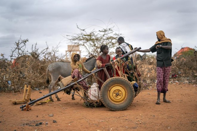 A Somali family that arrived waits to be given a spot to settle at a camp for displaced people on the outskirts of Dollow, Somalia on Tuesday, Sept. 20, 2022. Somalia has long known droughts, but the climate shocks are now coming more frequently, leaving less room to recover and prepare for the next. (AP Photo/Jerome Delay)