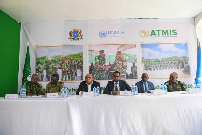 The Special Representative of the Chairperson of the African Union Commission (SRCC) for Somalia, Ambassador Mohamed El-Amine Souef (third from left), Somalia's State Minister of Defense Abdinur Dahir Fidow (third from right), the Director of the United Nations Support Office in Somalia (UNSOS), Amadu Kamara, (second from right) and senior ATMIS military and police personnel during the official handover of Maslah Forward Operating Base (FOB) in Mogadishu, Somalia, on 21 January 2023. ATMIS Photo / Mukhtar Nuur