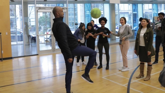 Immigration minister meets with youth group, plays soccer