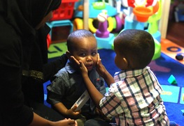 Day-care helper Saud Ahmed, left, watched as 3-year-old Ismail comforted 14-month-old Ibrahim.