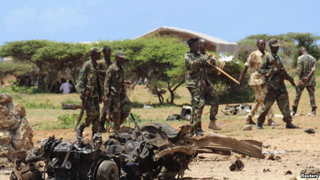 Jubaland forces walk near the site of an Aug. 22, car bomb attack near a military training base south of Mogadishu.