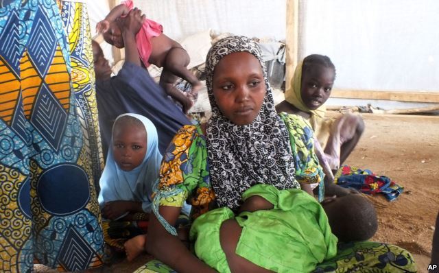 A family of refugees that fled their homes due to violence from the Islamic extremist group Boko Haram sit inside a refugee camp in Minawao, Cameroon, Feb. 25, 2015.