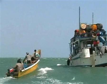 Pirates on speedboat approach one of their mother boats docked near Eyl, Somalia in this framegrab made from a November 24, 2008 TV footage.REUTERS