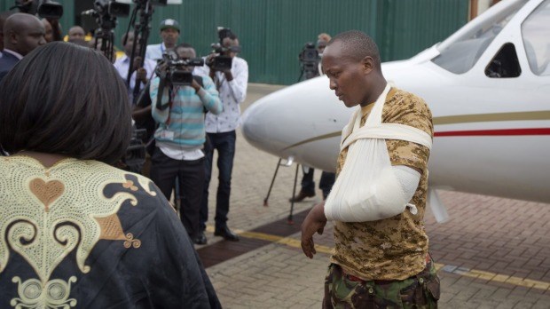 A Kenyan soldier, who Kenya Defence Forces said was injured in the attack by al-Shabab in Somalia earlier this week, walks from the airplane to a waiting ambulance after being airlifted back to Nairobi. Photo: AP