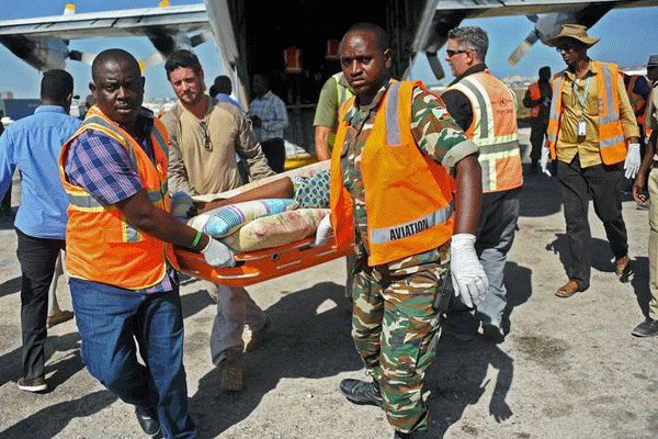 United Nations and AMISOM staff medics help wounded civilians at Mogadishu airport on February 29, 2016, after at least 30 people have been killed in twin bomb attacks claimed by Al-Shabaab in Baidoa. Amisom is struggling to adapt to a rural counter-insurgency after its eventual success in urban combat pushed Al-Shabaab out of Mogadishu five years ago. PHOTO | MOHAMED ABDIWAHAB |  AFP