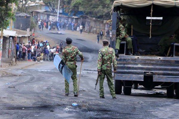 Police officers patrol Kibra streets in Nairobi on August 12, 2017 during protests by residents. Kenya police killed close to 50 people in Nairobi in the aftermath of the August 8 poll, Amnesty International and Human Rights Watch research shows. PHOTO | FILE | NATION MEDIA GROUP