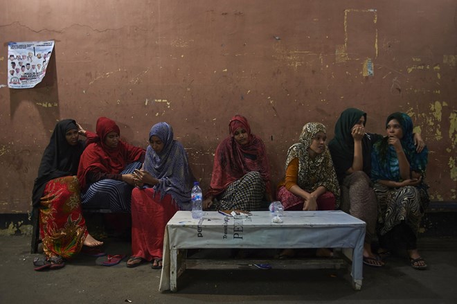 Somalia refugee women sit at the Mosque of al-Barokah in Jakarta for safety at night. Like many refugee women smuggled from their country to Indonesia after al-Shabaab militants raped them or murdered their family, they have fallen through the aid safety net and live on the street.
Photograph: Aaron Bunch/AAP
