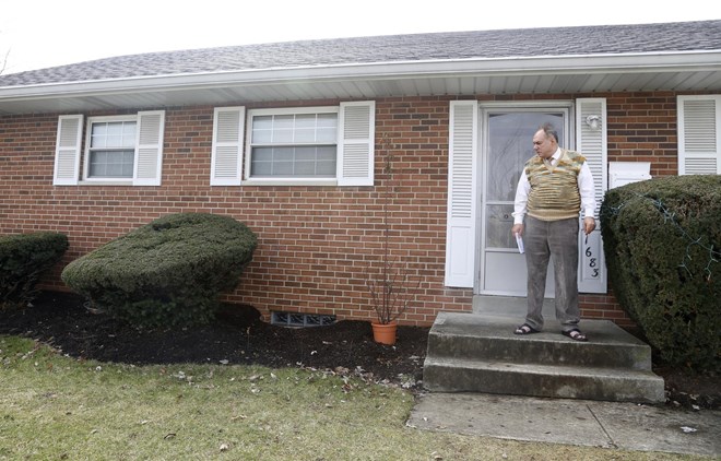 Rifat Moustafa, a Syrian immigrant, takes a smoke break outside his Columbus, Ohio, home on Thursday, Feb. 22, 2018. His 16-year-old son, Hasib Moustafa Rifat, has been separated from his family for more than 18 months as he awaits a U.S. visa. Moustafa, an international lawyer who says he was tortured for protesting human rights violations, was granted asylum and his wife and four other children followed in 2016, before President Trump was elected. They were hoping Hasib could come shortly after, but resettlement officials say the Trump administrationвЂ™s travel ban on refugees from mostly Muslim countries has very likely caused further delays. (AP Photo/martha Irvine)