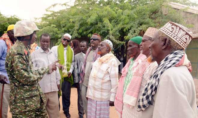 Col. Bonny Bamwiseki chatting with chiefs and elders at Ceerjaale in Somalia. PHOTOS: Eddie Ssejjoba