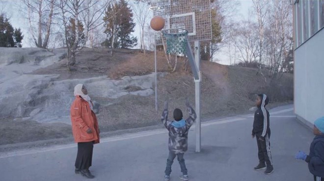 Iman is a keen basketball player and plays with a team set up by the night patrol mothers. [Al Jazeera]