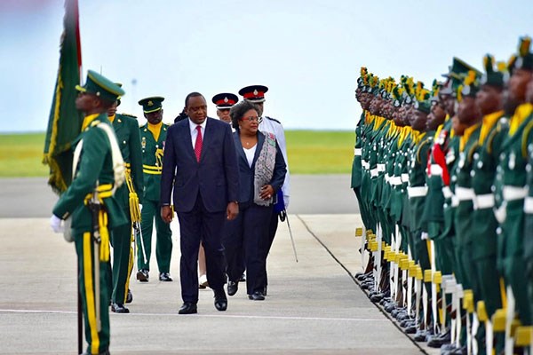 President Uhuru Kenyatta and Barbados Prime Minister Mia Mottley inspect a guard of honour after the Kenyan leader arrived in the capital Bridgetown. PHOTO | COURTESY