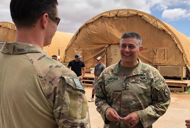 Gen. Stephen Townsend, commander of U.S. Africa Command, presents a coin to a service member who is helping to train Somali forces in in Somalia. Townsend recognized the contributions made by U.S. units involved in helping the Somalis build defense capabilities. (AFRICOM)
