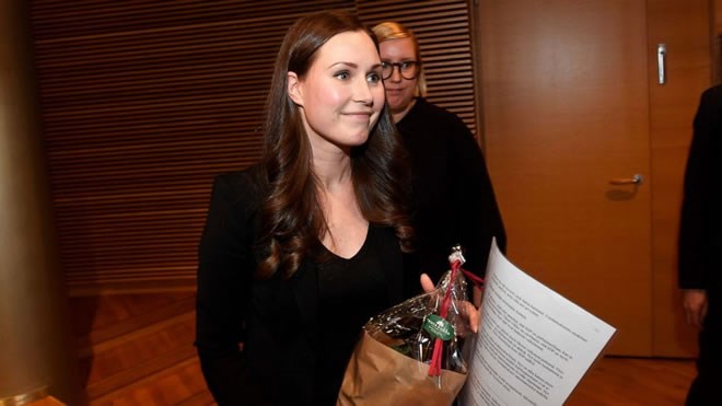 The candidate for the next Prime Minister of Finland, Sanna Marin, smiles after she won the SDP's Prime Minister candidate vote against Antti Lindtman, in Helsinki, Finland, Sunday, Dec. 8, 2019. A 34-year-old minister and lawmaker has been tapped to become Finland's youngest prime minister ever and its third female government head, replacing former Cabinet leader who resigned Tuesday. (Vesa Moilanen/Lehtikuva via AP)