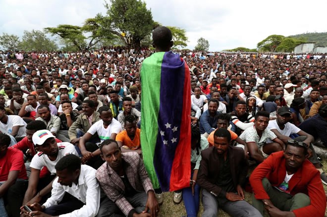 A sidama youth leader carrying a flag addresses people as they gather for meeting to declare their own region in Hawassa, Ethiopia July 17, 2019. REUTERS/Tisksa Negeri